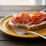 Close up of slicing avocado toast with smoked salmon