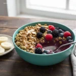 Fruit Smoothie Bowl: Your 1 Go-To Breakfast 6 Spoon scooping creamy strawberry fruit smoothie bowl