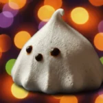 Ghost Meringues: 2 Easy Steps to Spooky Fun 3 Hand picking up a delicious ghost meringue.