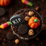 Graveyard Pudding Cookie Cup with gummy worm on marble