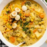Spoon lifting One-Pot Creamy Vegetable Soup