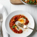 Shakshuka: Why 9 Chefs Love This Dish 6 Shakshuka in a bowl with a fork ready to eat