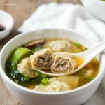 Quick & Easy Wonton Soup: How 1 Bowl Saves Dinner 6 Spoon lifting a wonton from Quick Easy Wonton Soup
