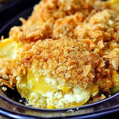 Squash Casserole: The Ultimate 4-Ingredient Recipe 2 A golden-brown squash casserole with a crispy topping in a white baking dish.