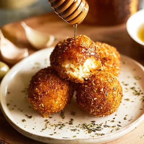 Goat Cheese Balls: 4 Delicious Dipping Sauces 2 A close-up shot of golden crispy fried goat cheese balls on a platter.