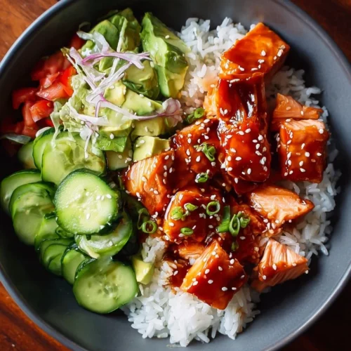 Honey Sriracha Salmon Bowls: A Sweet and Spicy Delight 2 Honey Sriracha Salmon served in a bowl garnished with vegetables and rice