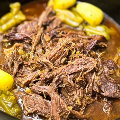 A hearty Mississippi Pot Roast cooking slowly in a crockpot.
