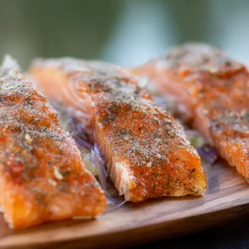 Smoked Salmon: 7 Recipe Ideas You'll Love 2 Close-up of thinly sliced smoked salmon on a bed of greens