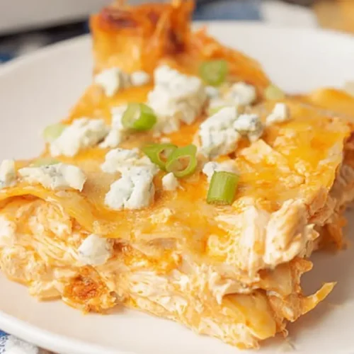 A hot dish of cheesy buffalo ranch chicken lasagna with bubbly cheese and chicken