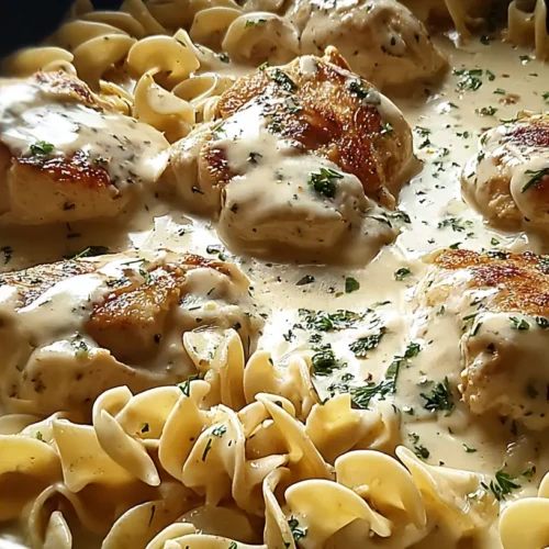A serving of tender chicken with buttered noodles.