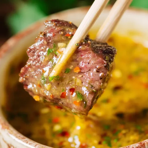 Cowboy Butter Dipping Sauce: How to Make 1 Perfect 2 A small bowl of creamy cowboy butter dipping sauce on a rustic wooden surface.