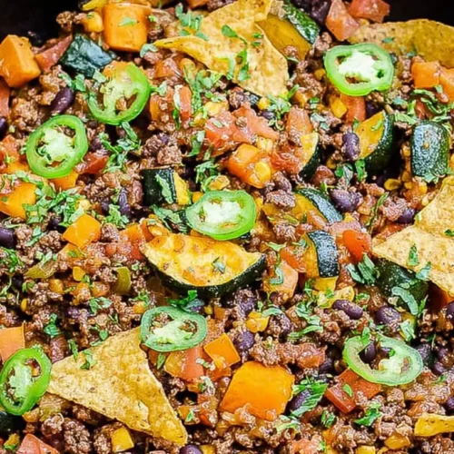 Ground Beef Veggie Skillet: 5 Easy Weeknight Meals 2 A close-up of a sizzling ground beef veggie skillet with vibrant vegetables.