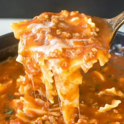 Lasagna Soup: Why You Need 1 Bowl Now 2 Close-up of a steaming bowl of hearty lasagna soup with ricotta and herbs.