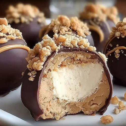 A serving of no bake peanut butter cheesecake balls on a white plate.