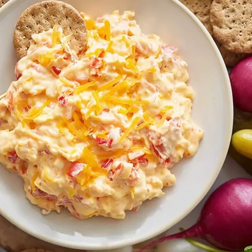 Pimento Cheese Spread: 10 Best Dips 2 A bowl of rich, creamy pimento cheese spread, garnished with fresh chives.