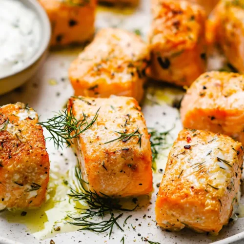 Closeup of perfectly cooked salmon bites arranged on a platter