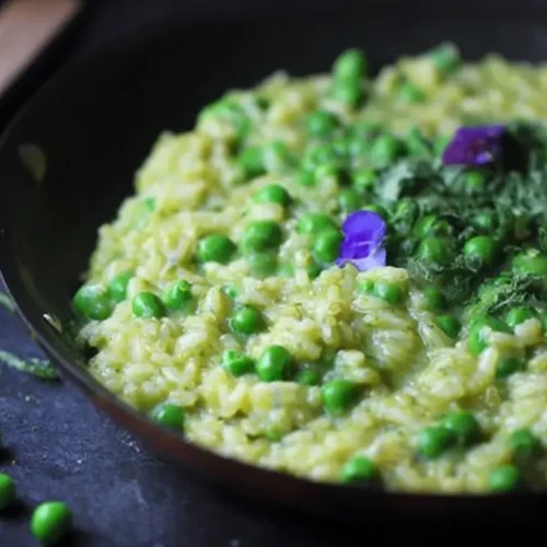 Spring Pea Risotto: 5 Tips for Perfection 2 A vibrant bowl of spring pea risotto garnished with herbs.