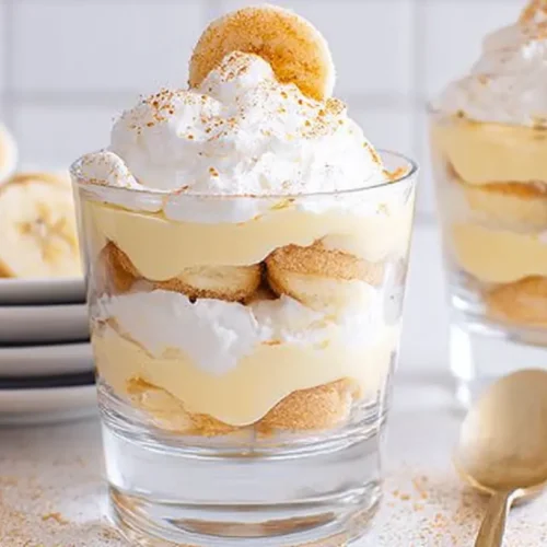 A bowl of creamy sugar free banana pudding topped with sliced bananas and whipped cream
