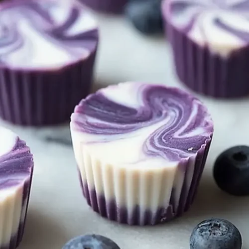 Blueberry Swirl Yogurt Bites: The 3 Best Flavors 2 Close-up of frozen blueberry swirl yogurt bites arranged on a white plate