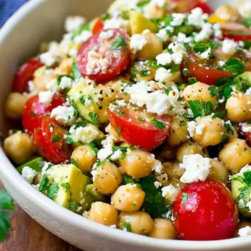 Chickpea Feta Avocado Salad: The 1 Ultimate Summer Lunch 2 A refreshing Chickpea Feta Avocado Salad in a white bowl