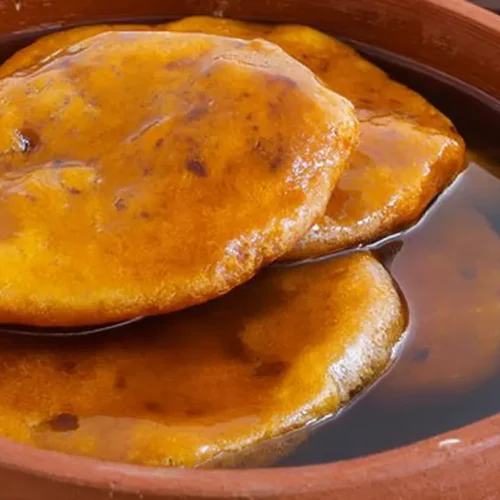 Sopaipillas: Your 1 Guide to Frying Firm 2 A plate of golden-brown sopaipillas dusted with powdered sugar