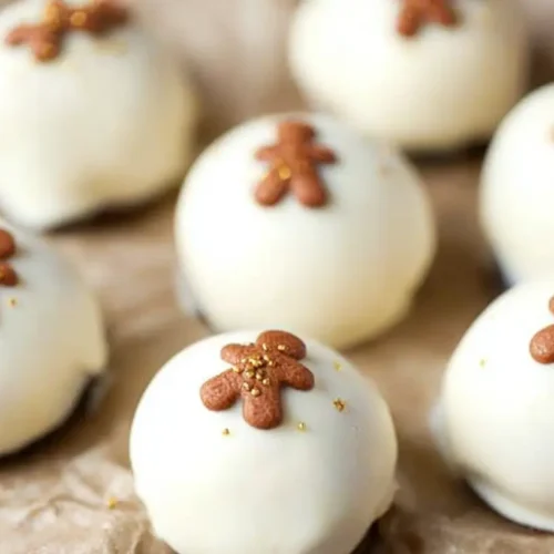 Gingerbread Oreo Truffles: 5 Easy Steps to Sweetness! 2 Delicious gingerbread Oreo truffles coated in white chocolate and sprinkles