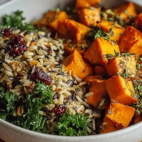 A hearty wild rice bowl with vibrant sweet potatoes and fresh kale.
