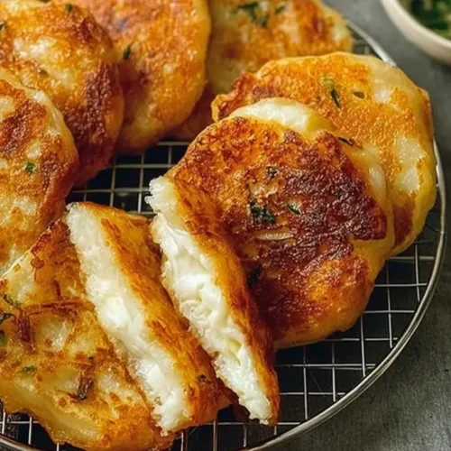 A close-up of a Korean Hotteok Potato Cheese Pancake, golden brown and perfectly cooked.
