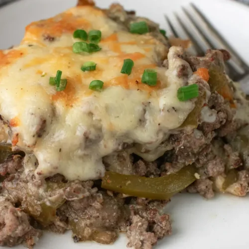 A low carb Philly cheesesteak casserole with melted cheese and steak