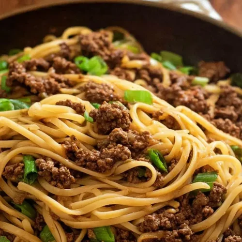 Mongolian Ground Beef Noodles: How to Make 1 Perfect Bowl 2 A close-up of Mongolian ground beef noodles in a bowl, showing the savory sauce and tender beef.