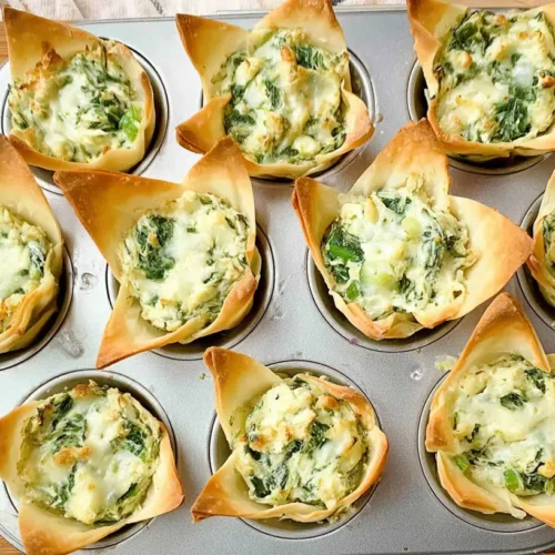 Spinach and artichoke dip cups displayed on a platter