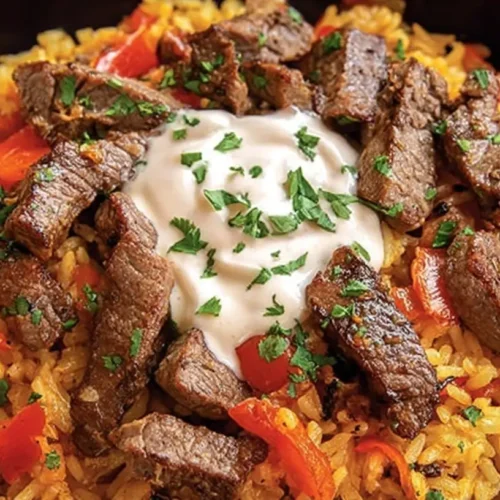 Steak Queso Rice : A Flavorful Recipe: The 3 Taste Secrets 2 A serving of Steak Queso Rice on a plate, rich with melted cheese and tender steak