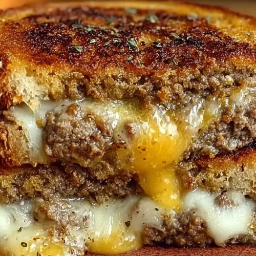 A close-up of an ultimate cheesy ground beef melt, showcasing melted cheese and savory beef.