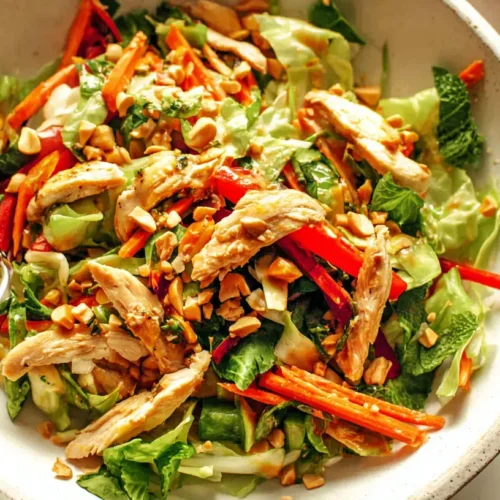 Chicken Thai Crunch Salad — cabbage, herbs, peanut-lime dressing: 5 Reasons Why It's Your New Favorite 2 A vibrant Chicken Thai Crunch Salad with shredded cabbage, fresh herbs, and a peanut-lime dressing.