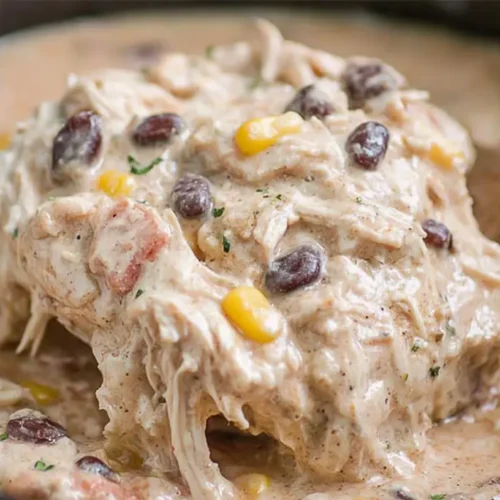 Crockpot Cream Cheese Chicken: 4 Dinner Ideas 2 Creamy crockpot cream cheese chicken garnished with fresh herbs in a slow cooker.