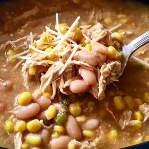 Crockpot Healthy White Chicken Chili: 3 Reasons to Try It 2 A bowl of Crockpot healthy white chicken chili garnished with fresh cilantro and lime.