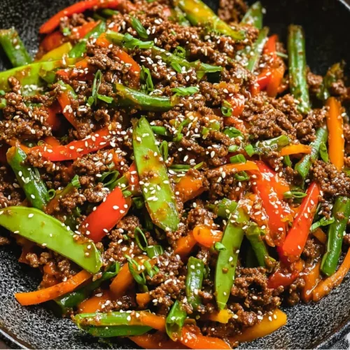 Ground Beef and Vegetable Stir Fry: The 1-Pan Wonder 2 A close-up of ground beef and vegetable stir fry in a wok with colorful vegetables.