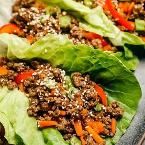 Lean Ground Beef Lettuce Wraps: Our Top 8! 2 Lean ground beef lettuce wraps prepared on a clean white plate