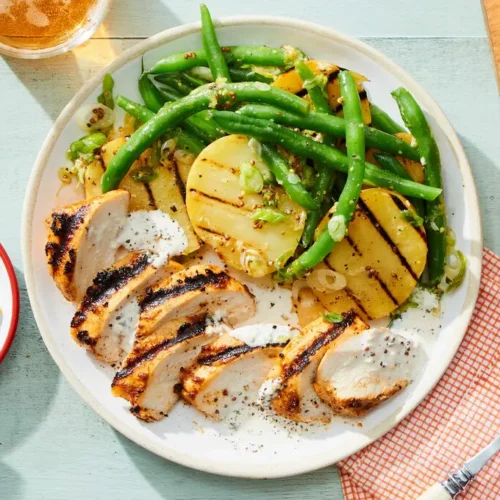 Grilled chicken coated in Alabama white chicken sauce