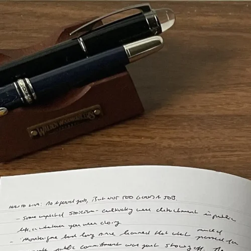Stack of various notebooks for note taking on a desk