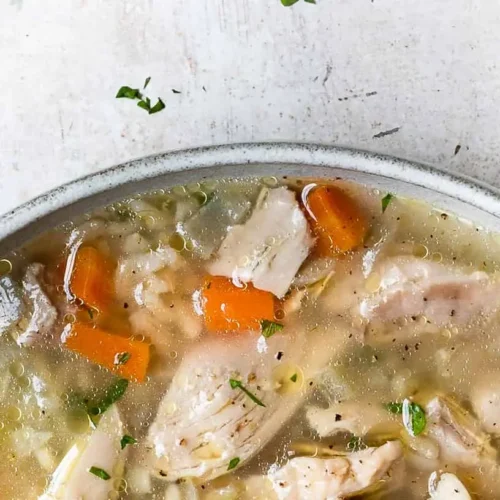 Chicken and rice soup: Which 4 are your favorites? 2 A steaming bowl of chicken and rice soup, garnished with fresh herbs.