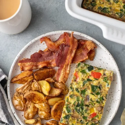 A freshly baked clean eating breakfast casserole in a baking dish, ready to serve.