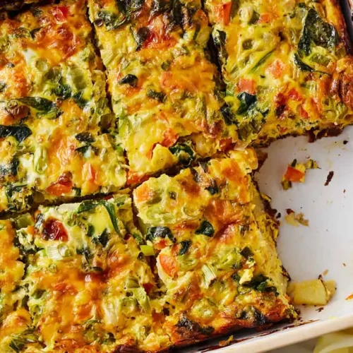 A baked effortless breakfast casserole dish with eggs, cheese, and sausage