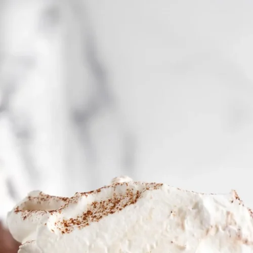 A rich Mississippi mud pie with chocolate layers, topped with whipped cream and chocolate shavings