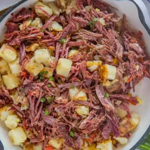 A serving of savory corned beef hash, freshly cooked and steaming