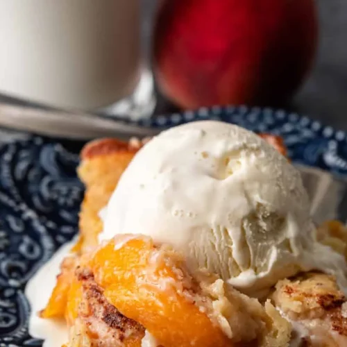 A freshly baked peach cobbler bubbling with fruit